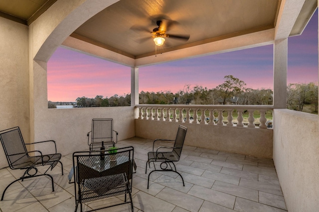 patio terrace at dusk featuring ceiling fan