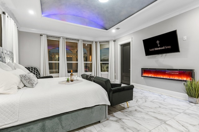 bedroom with a tray ceiling and ornamental molding