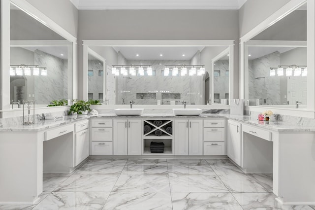 bathroom featuring crown molding, a tile shower, and vanity