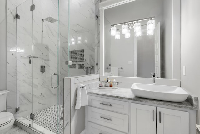 bathroom featuring walk in shower, vanity, and toilet