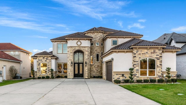 mediterranean / spanish-style house with a front lawn and a garage