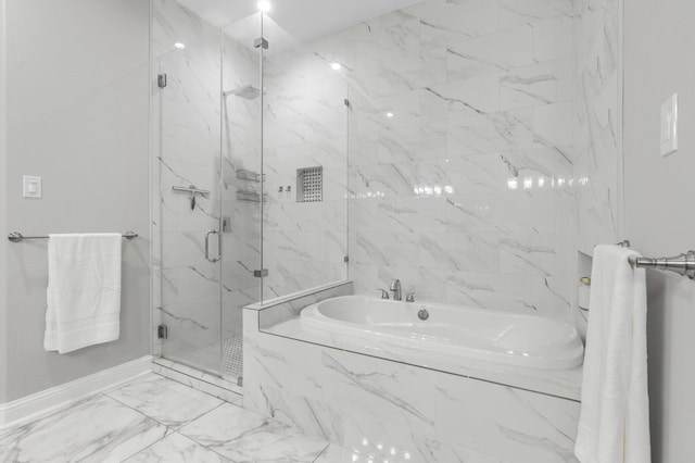 bathroom featuring shower with separate bathtub