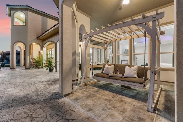 patio terrace at dusk featuring a pergola