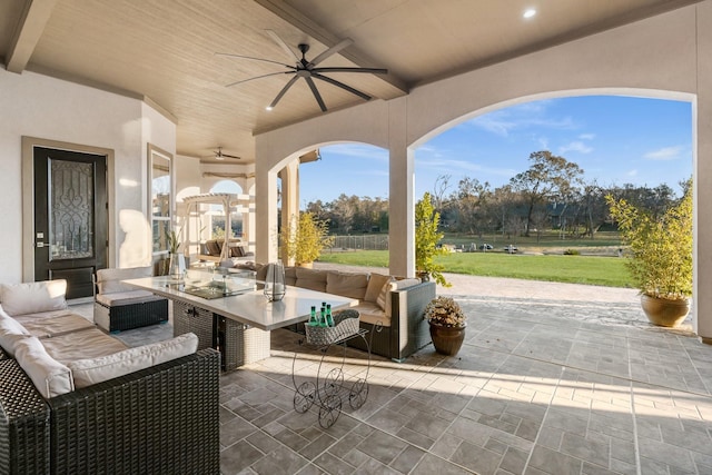 view of patio / terrace featuring ceiling fan and an outdoor living space