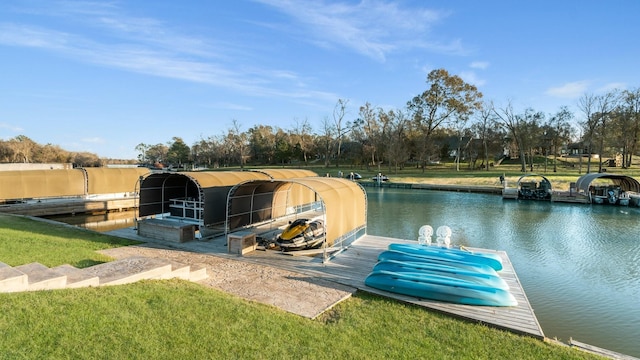 dock area with a water view and a yard