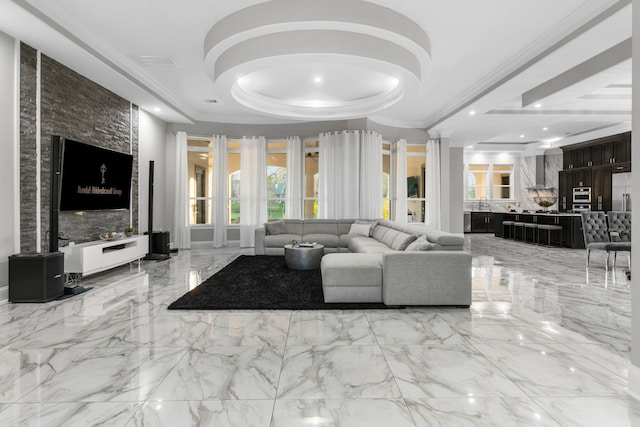 living room with a tray ceiling and crown molding