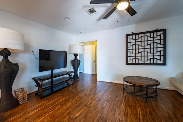 living area with visible vents, ceiling fan, baseboards, and wood finished floors