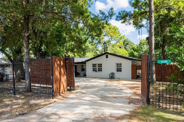 view of side of home featuring a gate and fence