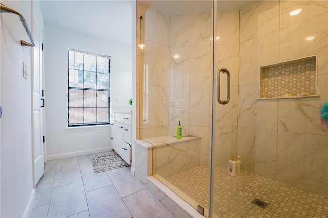 full bathroom featuring a stall shower, tile patterned floors, and baseboards