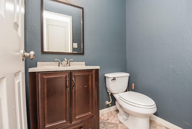 bathroom featuring toilet and vanity