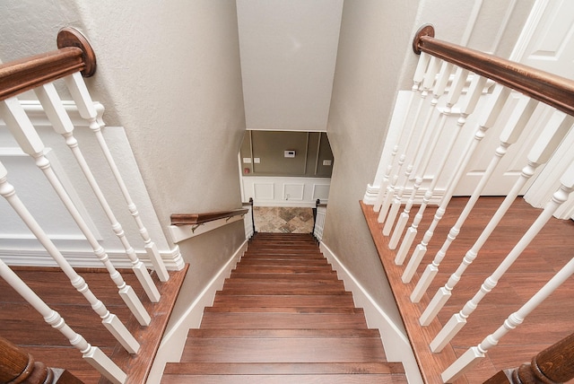 staircase with hardwood / wood-style floors