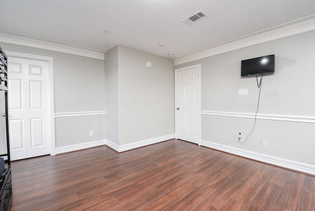 spare room with dark hardwood / wood-style flooring and crown molding