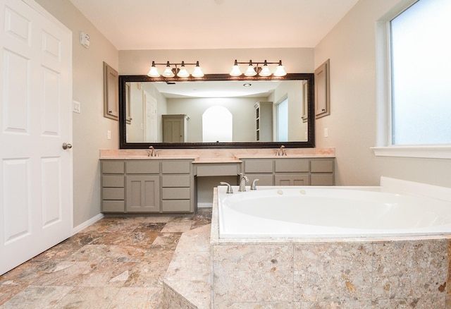 bathroom featuring vanity and a relaxing tiled tub