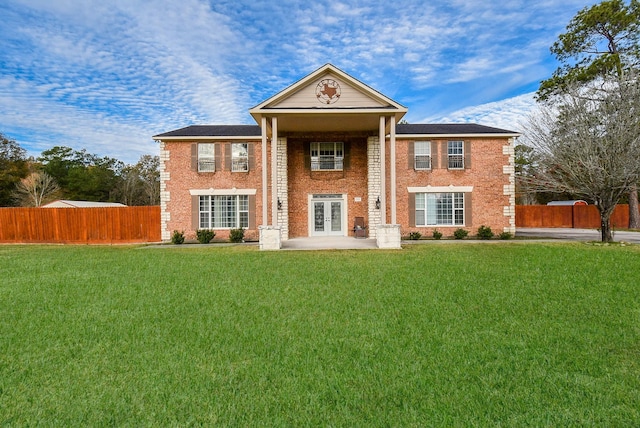 view of front of home with a front lawn and french doors