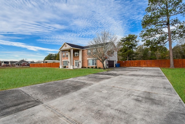 view of front facade with a garage and a front yard