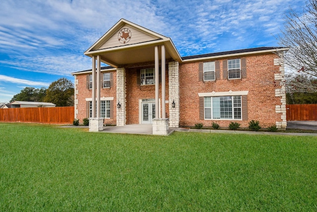 rear view of house featuring a lawn and a patio area