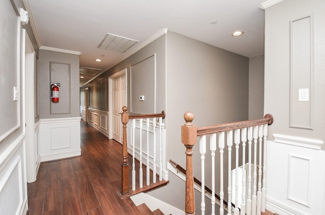 corridor with dark hardwood / wood-style floors and crown molding