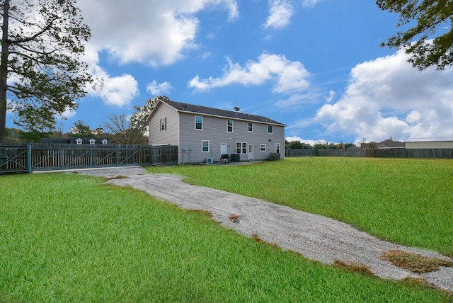 rear view of property with a lawn