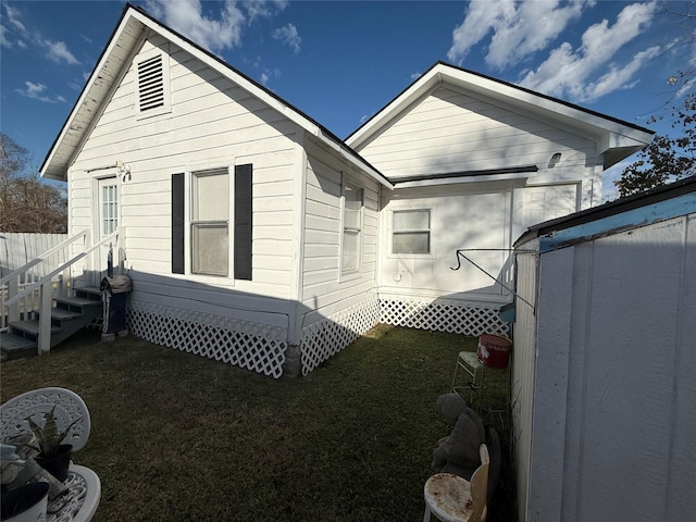 rear view of property with a yard