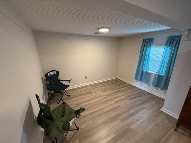 unfurnished room featuring light wood-type flooring and ornamental molding