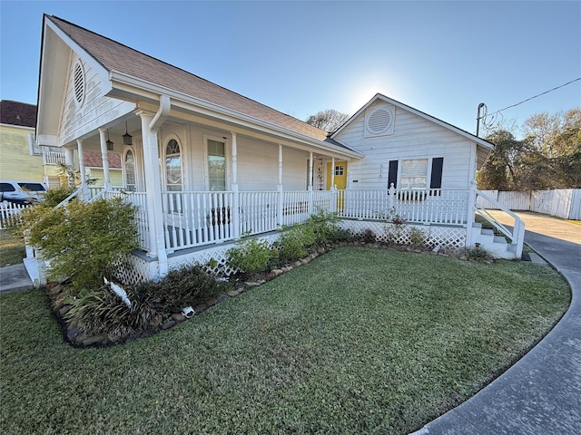 view of front of house with a front yard and a porch