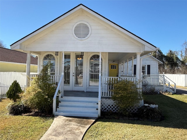 bungalow-style home with a porch and a front lawn