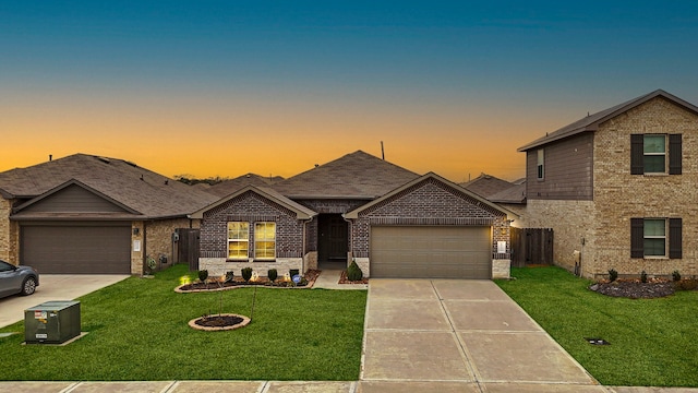 view of front of property featuring a garage and a lawn