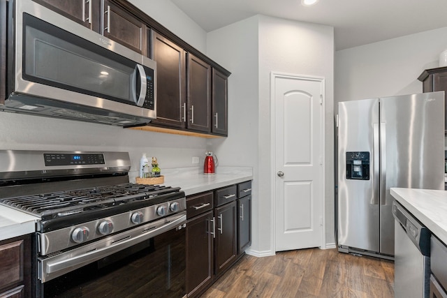 kitchen featuring dark brown cabinets, dark hardwood / wood-style floors, and stainless steel appliances