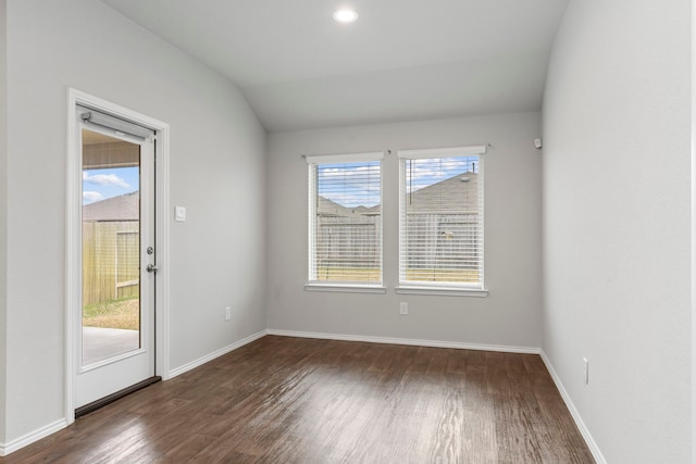 unfurnished room with lofted ceiling, dark wood-type flooring, and a wealth of natural light