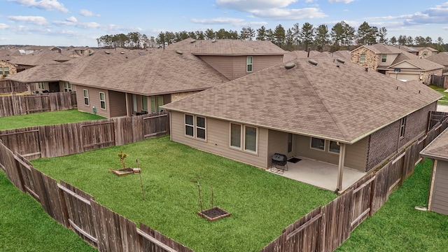 back of house with a yard and a patio