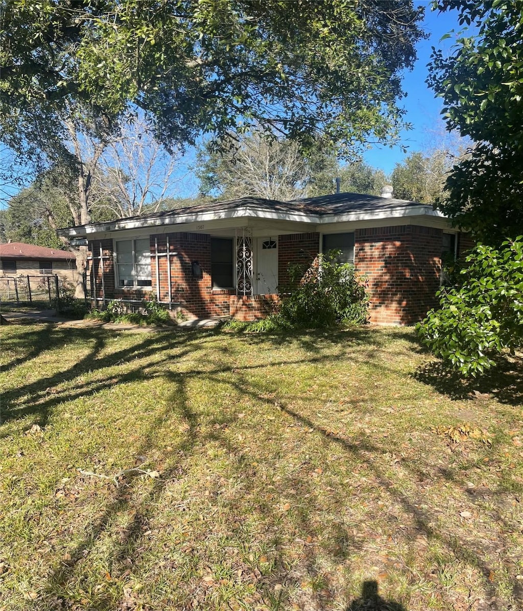 back of property with a lawn