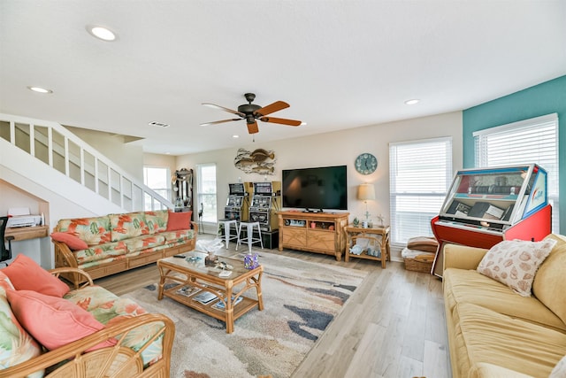 living room featuring ceiling fan and light hardwood / wood-style flooring