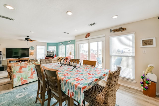 dining room with ceiling fan and light hardwood / wood-style flooring