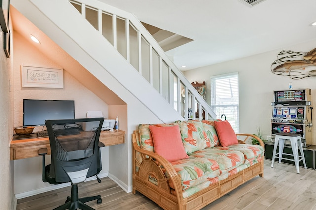 home office with light hardwood / wood-style floors