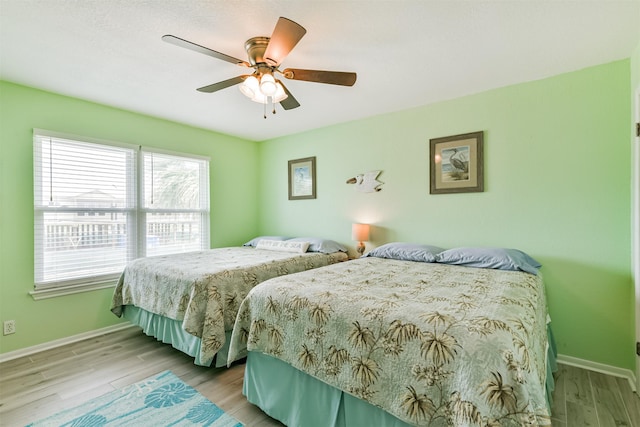 bedroom with ceiling fan and light hardwood / wood-style flooring