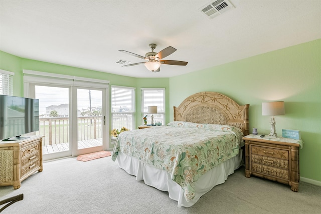 carpeted bedroom with ceiling fan and access to exterior