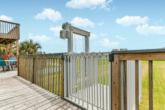 wooden deck with a lawn