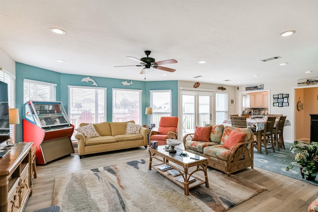 living room featuring light hardwood / wood-style floors and ceiling fan