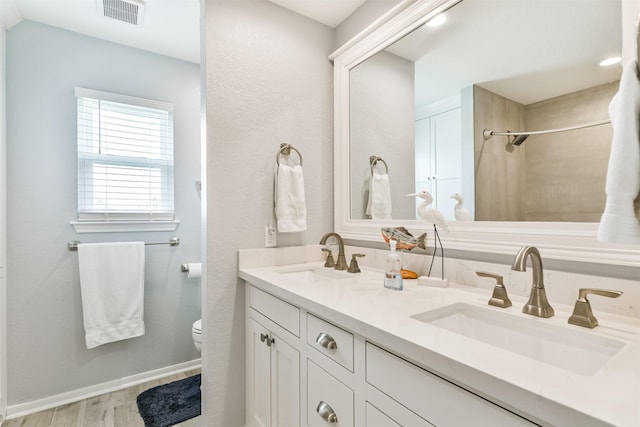 bathroom with hardwood / wood-style floors, toilet, and vanity