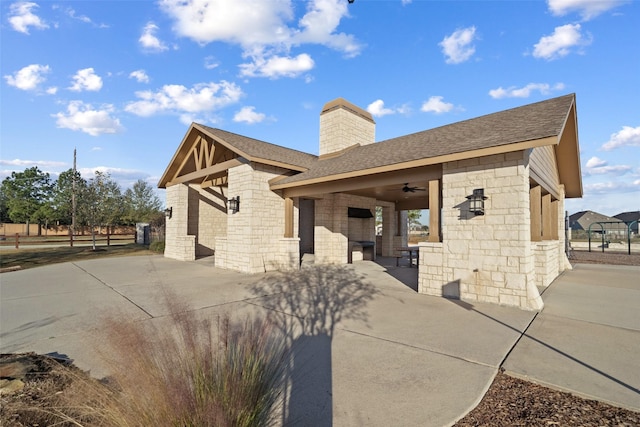 rear view of property with ceiling fan and a patio