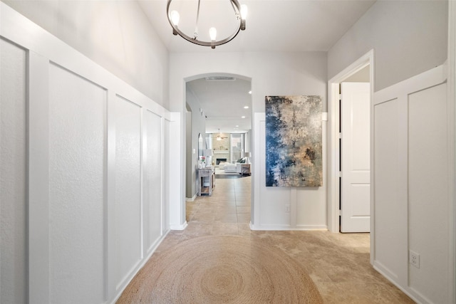 hallway featuring an inviting chandelier