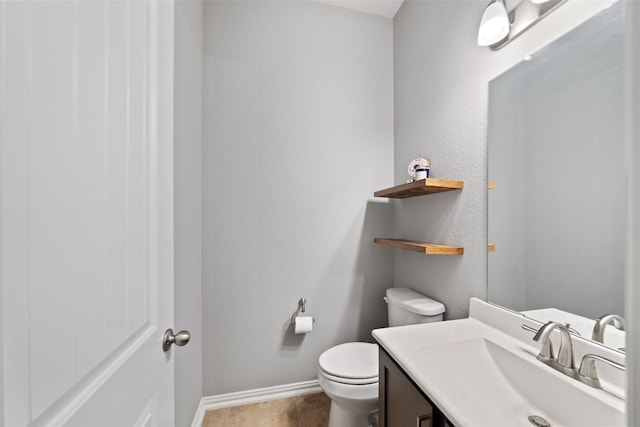 bathroom featuring toilet and vanity