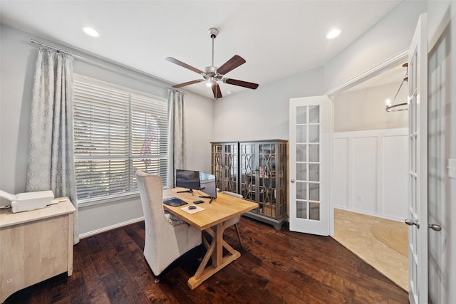 home office with ceiling fan, dark hardwood / wood-style flooring, and french doors