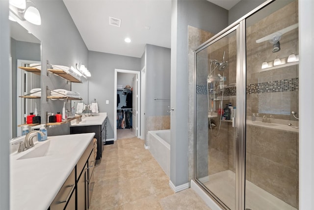 bathroom with vanity and independent shower and bath