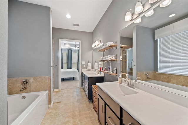 bathroom with tile patterned floors, vanity, and shower with separate bathtub