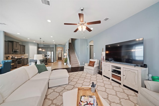 living room with light wood-type flooring and ceiling fan