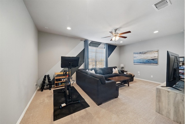 carpeted living room with ceiling fan