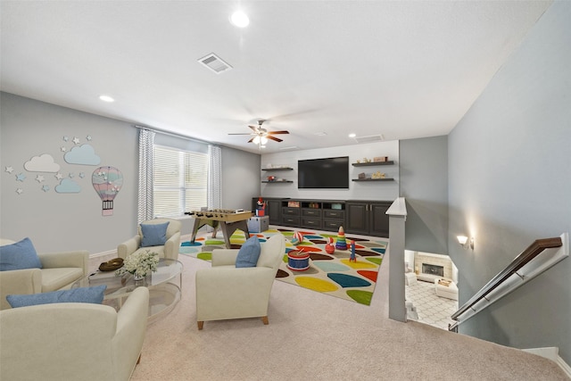 carpeted living room featuring ceiling fan