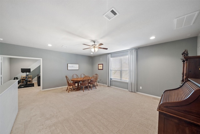 interior space with ceiling fan and light colored carpet