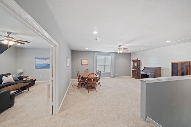 interior space featuring ceiling fan and light colored carpet